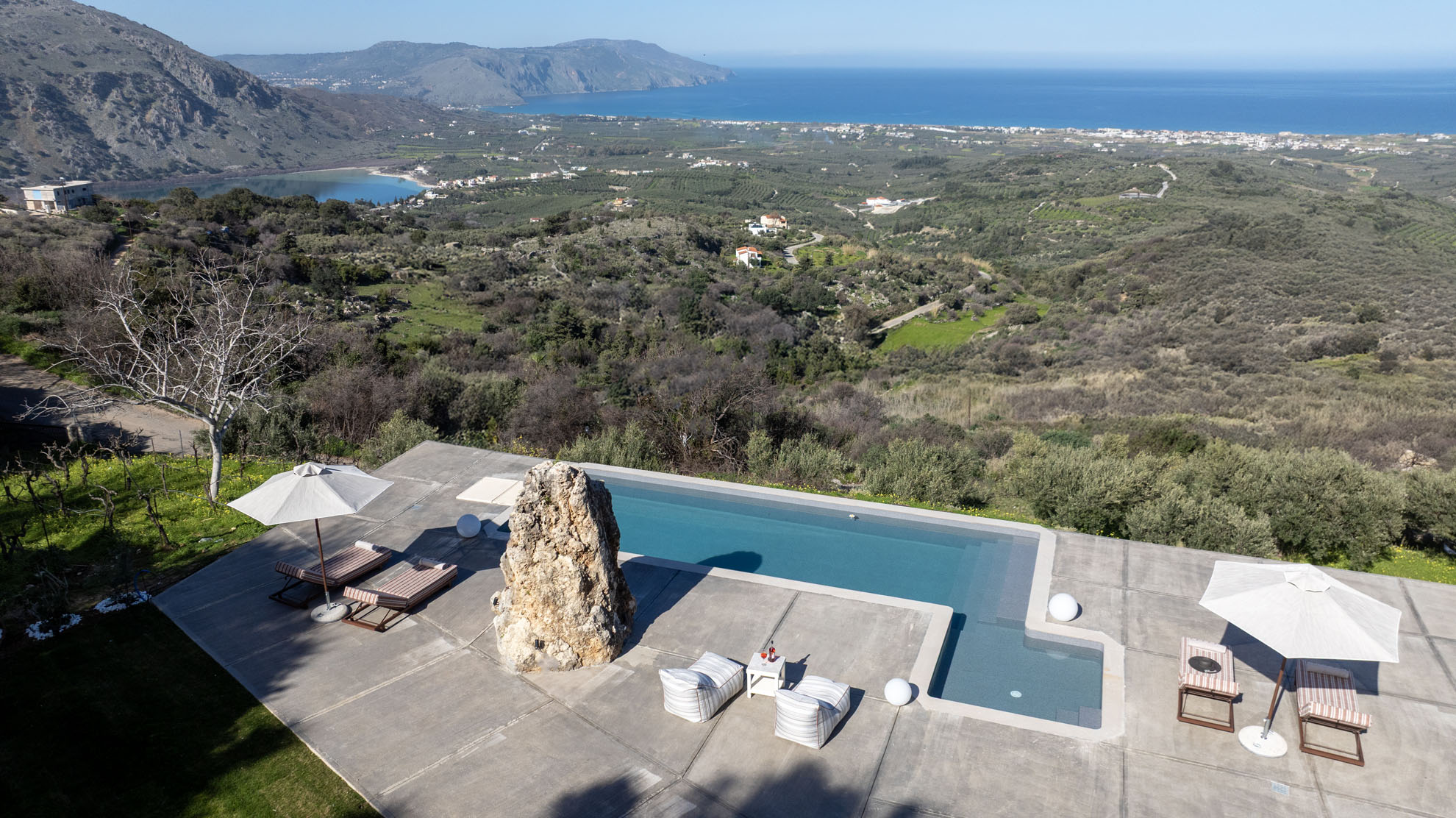 Guests enjoying Thea Villas pool and landscape